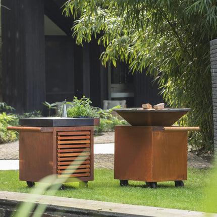 OFYR Heritage Classic 100 pro corten in graas aan rand van vijver met losse werktafe;